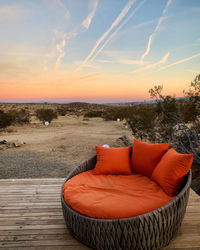 Panoramic shot of wicker basket on table against sky during sunset