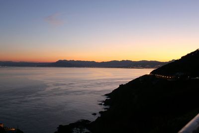 Scenic view of lake against clear sky during sunset