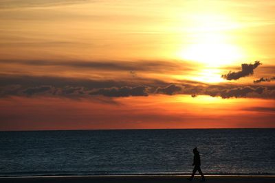 Scenic view of sea against orange sky