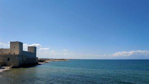 Scenic view of sea against blue sky