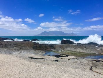 Scenic view of beach against blue sky