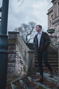 Full length of young man looking at building