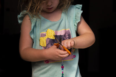 A child plays with colorful and shiny beads