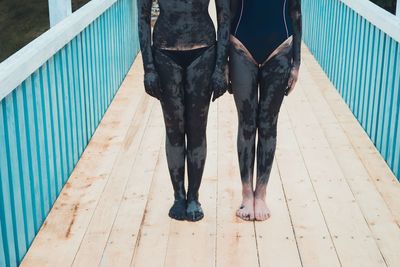 Low section of women covered in mud