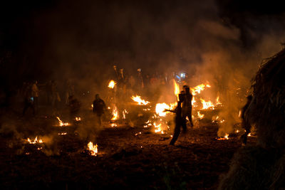 Group of people watching fire in the dark