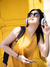 Midsection of young woman using mobile phone