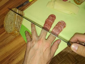 Midsection of person holding bread on table