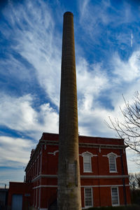 Low angle view of building against cloudy sky