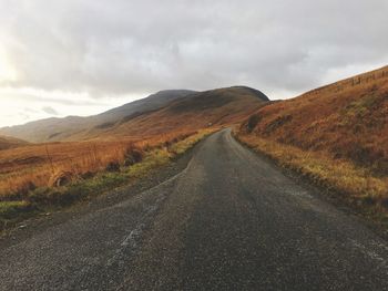 Road amidst landscape against sky