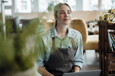 Portrait of a young woman sitting on table