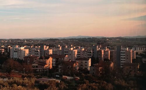 High angle view of buildings against sky during sunset