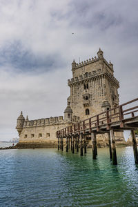 View of historic building against cloudy sky, tower of belém, lissabon, portugal