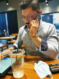 Midsection of man having food at restaurant