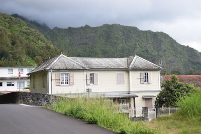 House by building against sky