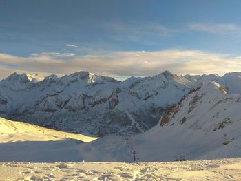 Scenic view of snowcapped mountains against sky