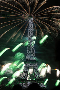 Low angle view of illuminated tower at night