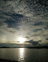 Scenic view of sea against dramatic sky during sunset