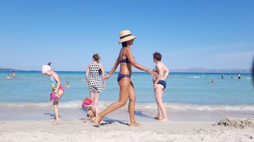 People on beach against sky