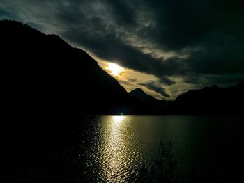 Scenic view of lake against sky at sunset