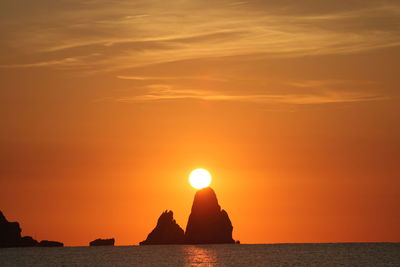 Scenic view of sea against orange sky