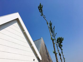 Low angle view of modern building against clear blue sky