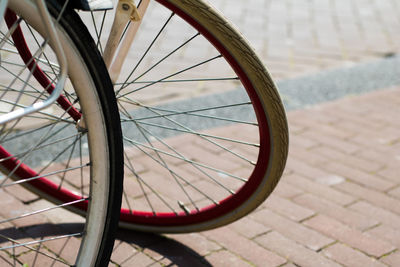 Close-up of bicycle wheel on sidewalk