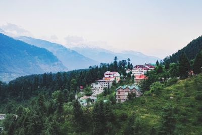 High angle view of townscape by mountain against sky