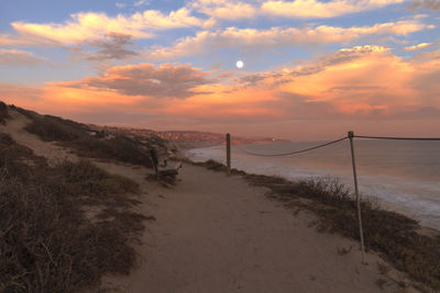 Scenic view of beach against sky during sunset