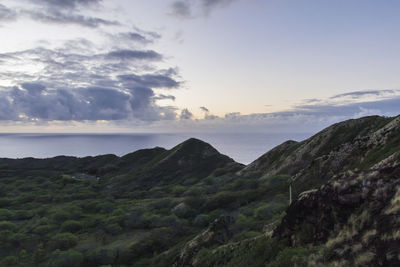 Scenic view of sea and mountains against sky