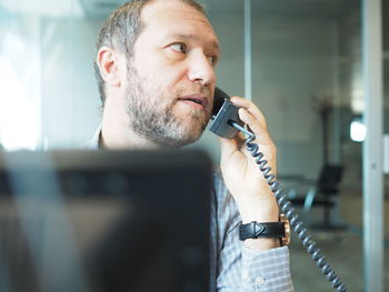 Close-up of man using mobile phone