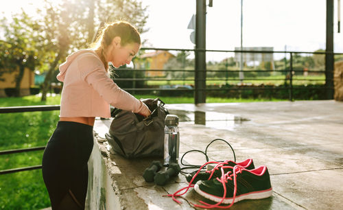 Sportswoman preparing equipment for training outside