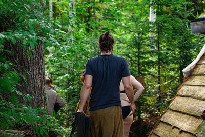 Rear view of a man standing in forest