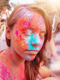 Portrait of woman with multi colored face