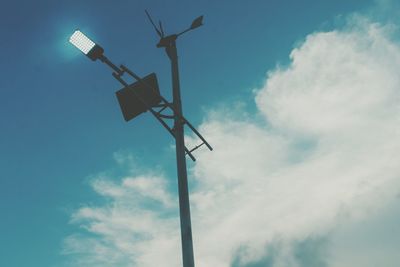 Low angle view of windmill against blue sky