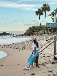 Full length of woman standing at beach