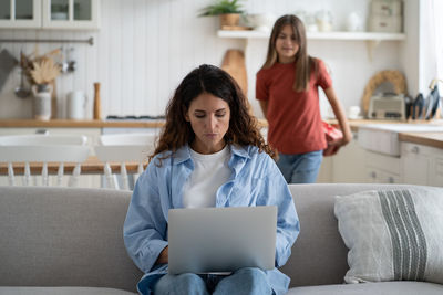 Young woman using laptop at home