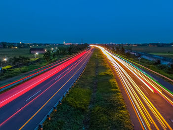 High angle view of light trails on highway at night