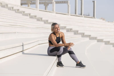 Female athlete sitting on steps