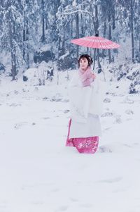 Woman standing on snow covered land