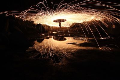 Illuminated fireworks against sky at night