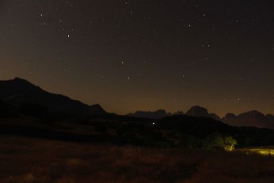 Scenic view of mountains against sky at night