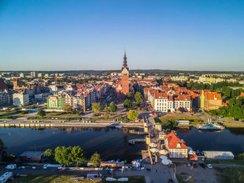 Aerial view of buildings in city against clear sky