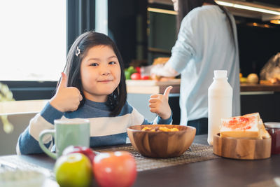 High angle view of girl having food on table