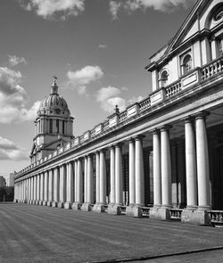 Low angle view of national maritime museum against cloudy sky