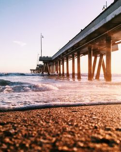 Low angle view of pier on beach