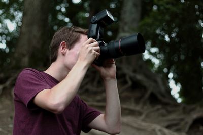 Man photographing in forest