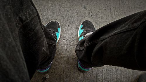 Low section of man wearing shoes