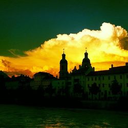 Built structure against cloudy sky at sunset