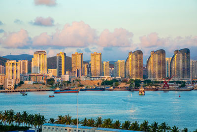 Buildings in city against cloudy sky