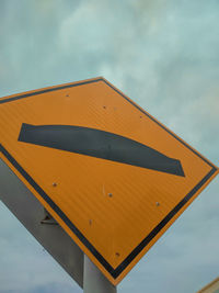 Low angle view of road sign against sky